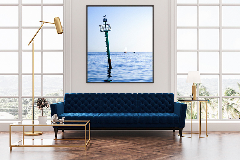 Fine Art displayed above a coach in a luxurious living space.
